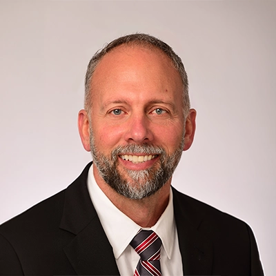Chiropractor Andrew Leitzke Smiling In A Suit
