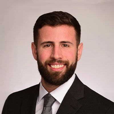 Chiropractor Tyler Leitzke Smiling In A Suit